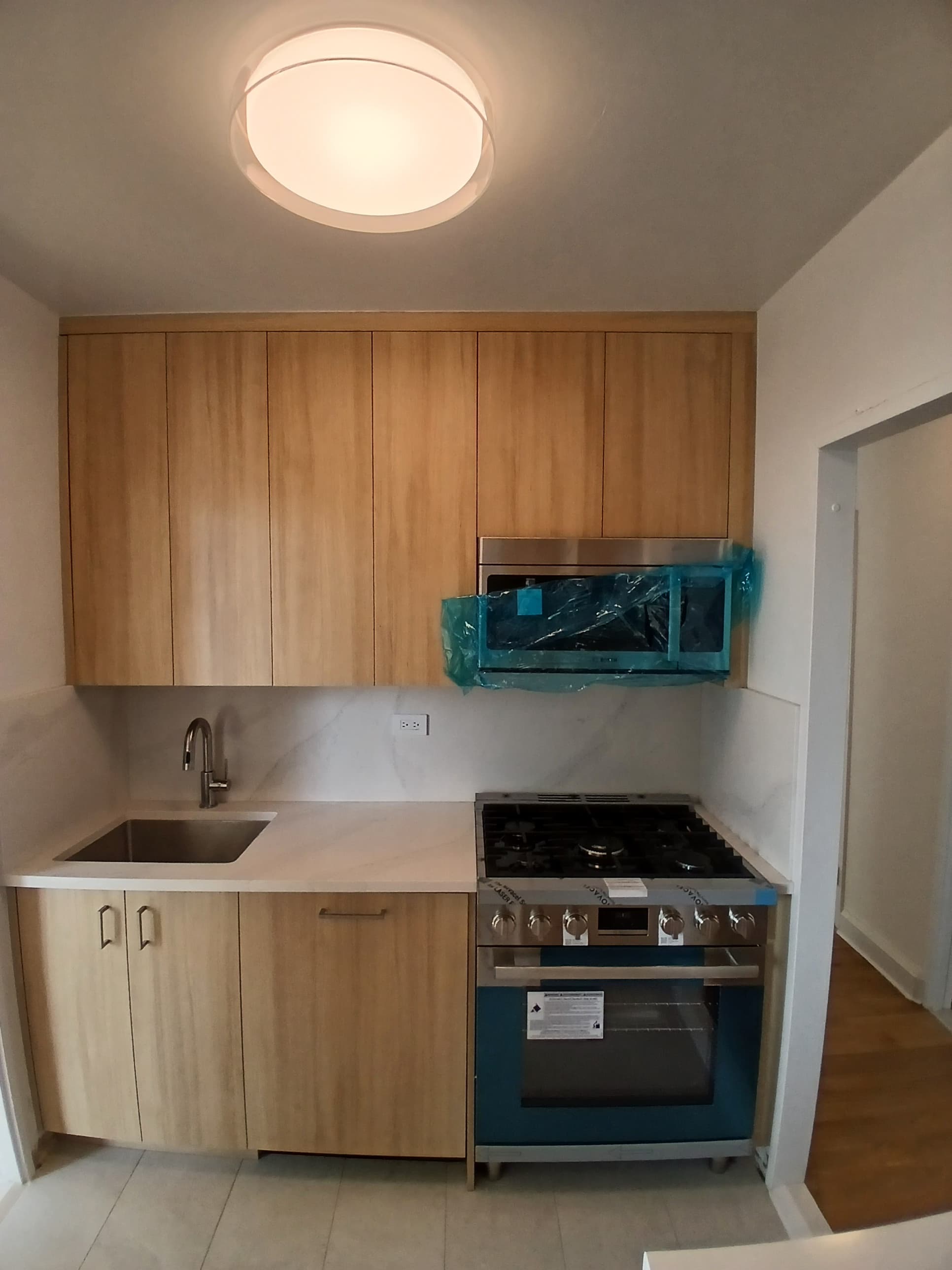 Finished kitchen installation with wood cabinets